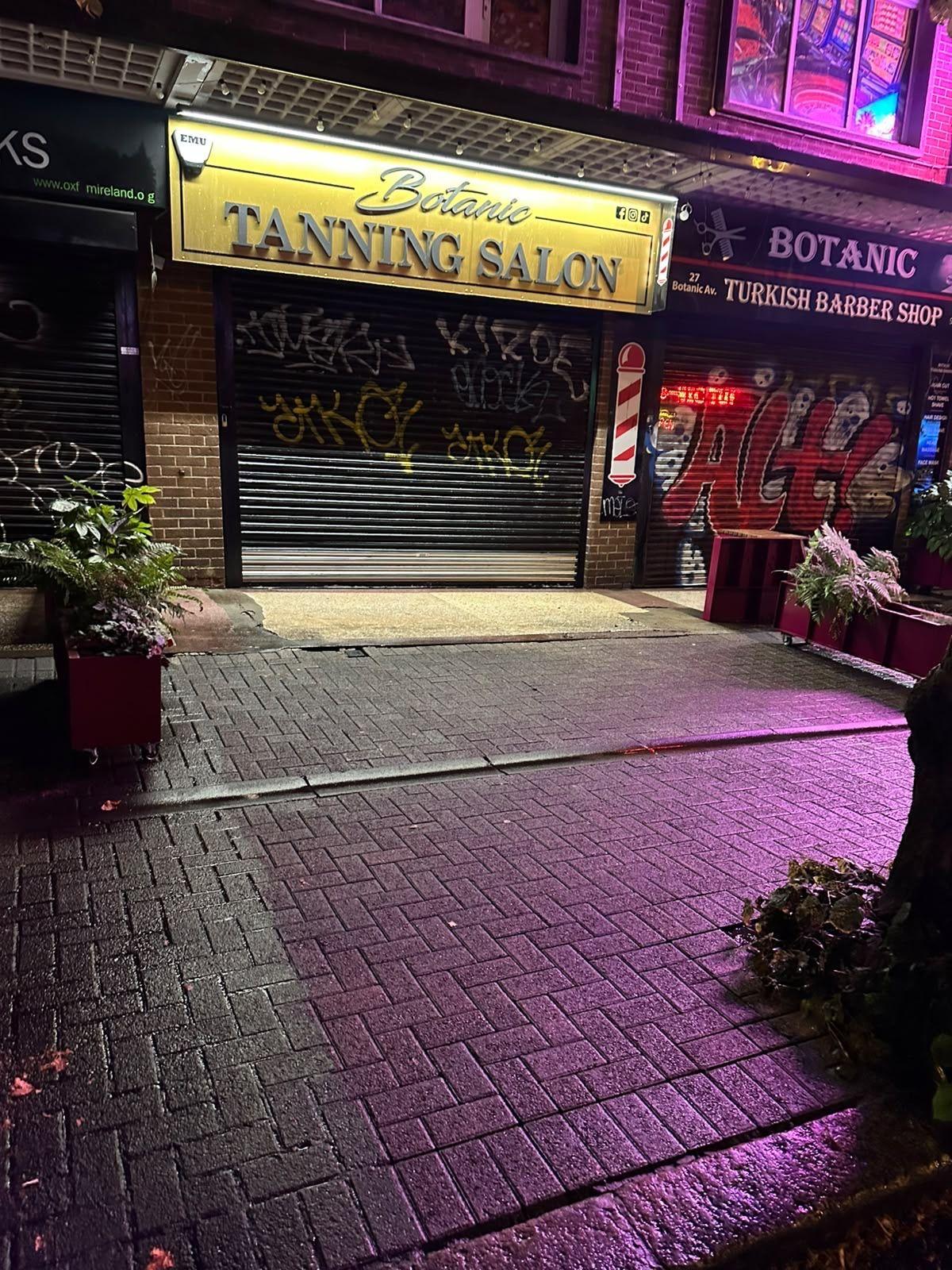 Paving outside a salon shopfront at night