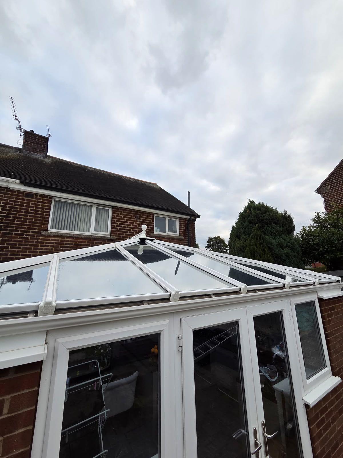 White uPVC conservatory on a red-brick house