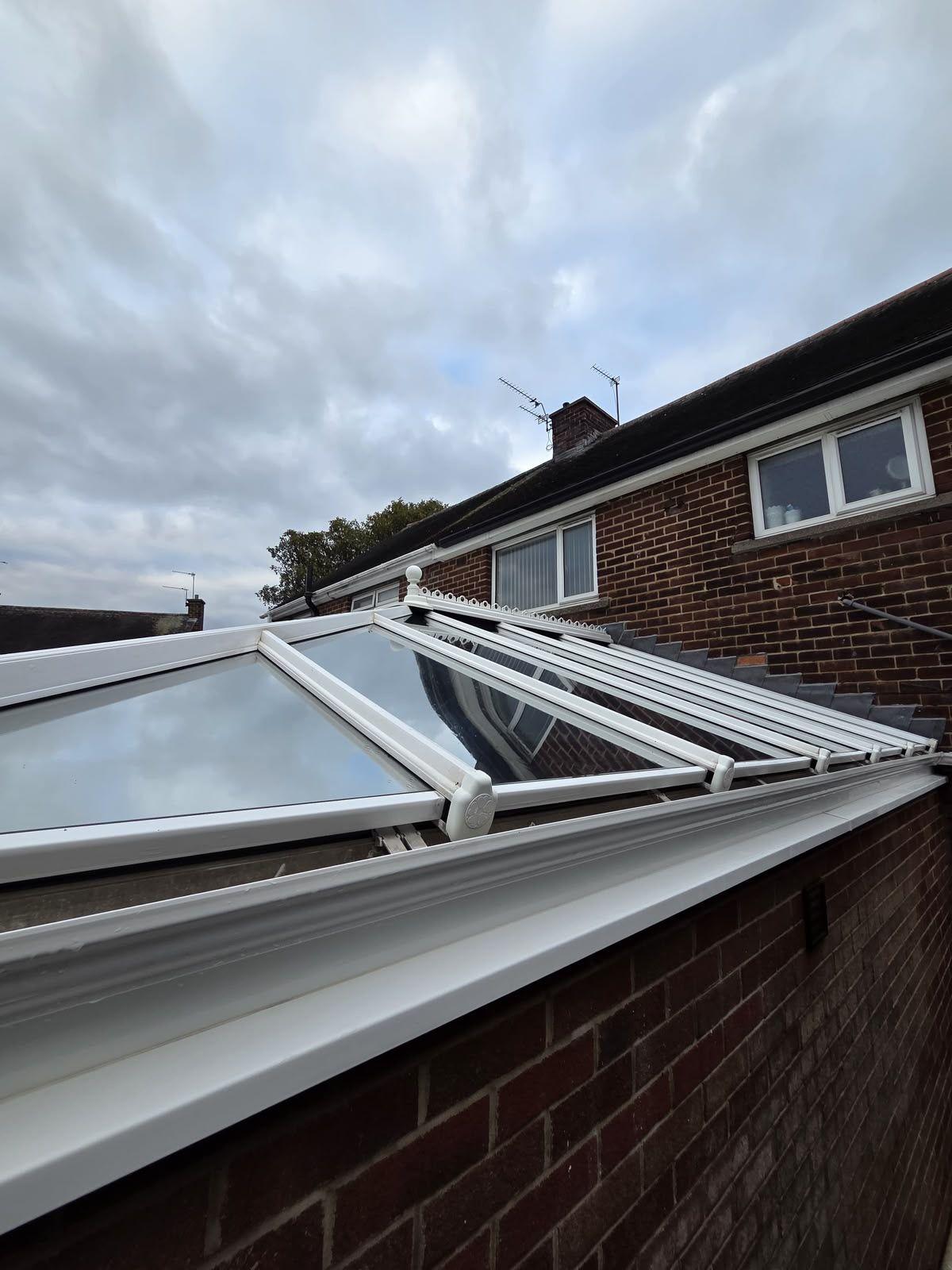 Conservatory roof and gutter on a red-brick house