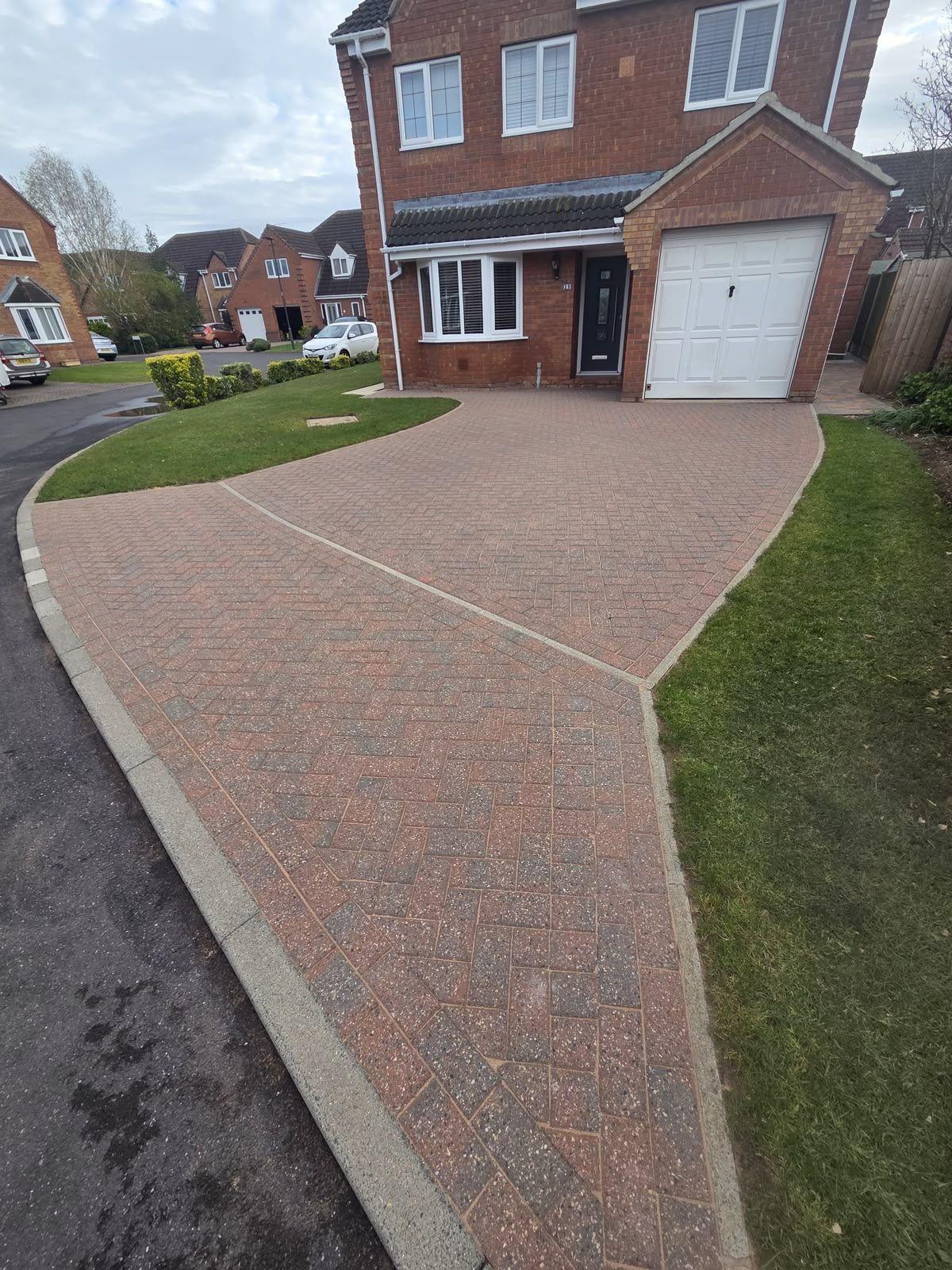 Herringbone block paving driveway in front of a house