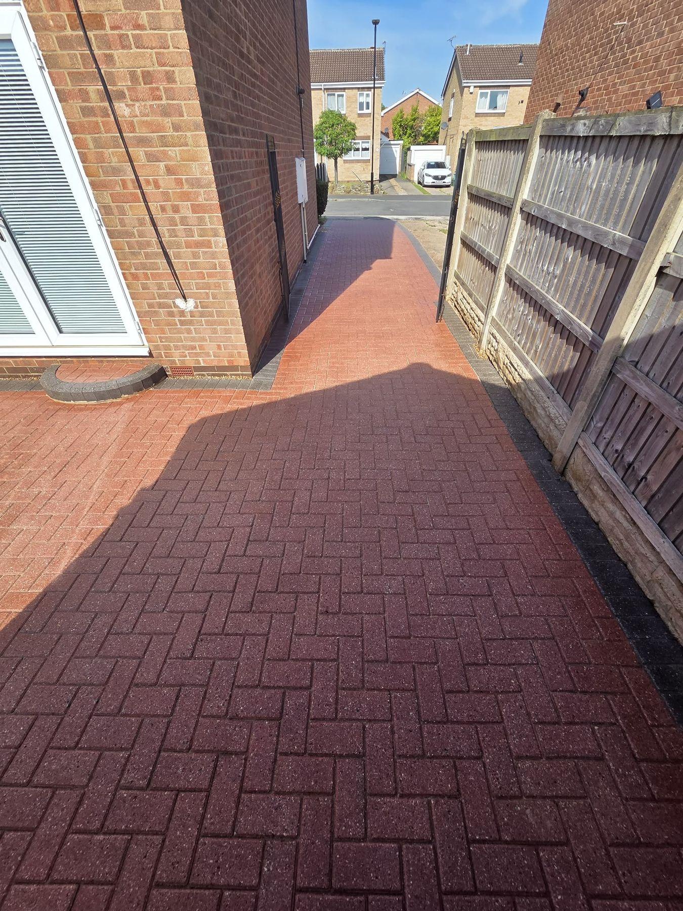 Block paving path down the side of a house