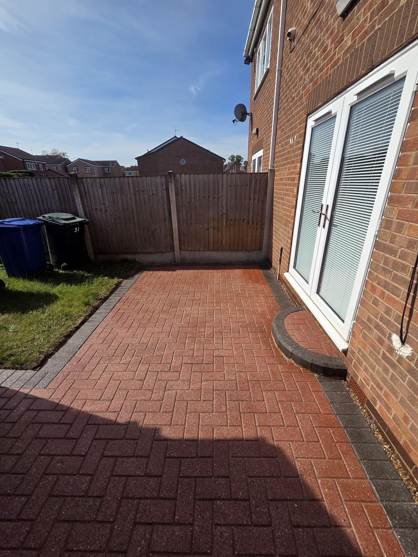 Herringbone block paving patio in a back garden